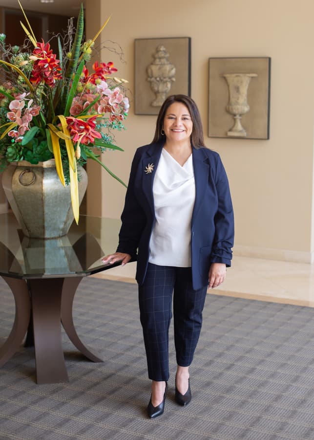 Carmen B. Marquez standing in the office lobby.